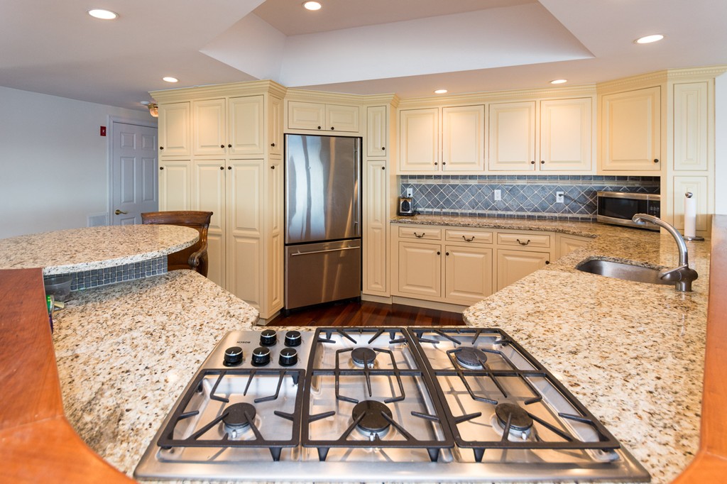 63 Oceanside Drive, Unit 63 Hull, MA 02045 - Photo 14 of 30 a kitchen with a refrigerator sink and cabinets