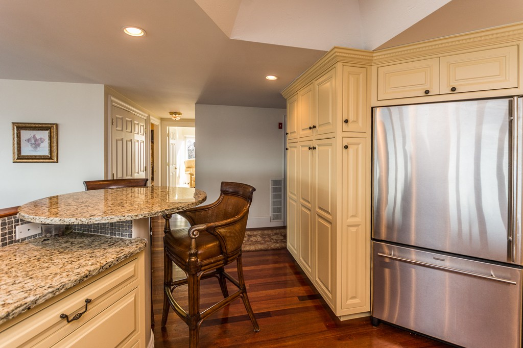 63 Oceanside Drive, Unit 63 Hull, MA 02045 - Photo 16 of 30 a kitchen with stainless steel appliances granite countertop a refrigerator and a stove top oven