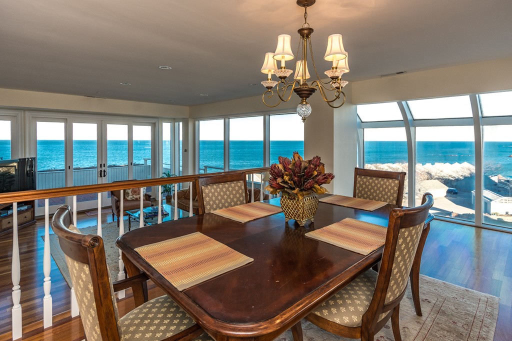 63 Oceanside Drive, Unit 63 Hull, MA 02045 - Photo 18 of 30 a view of a dining room with furniture a chandelier and large windows