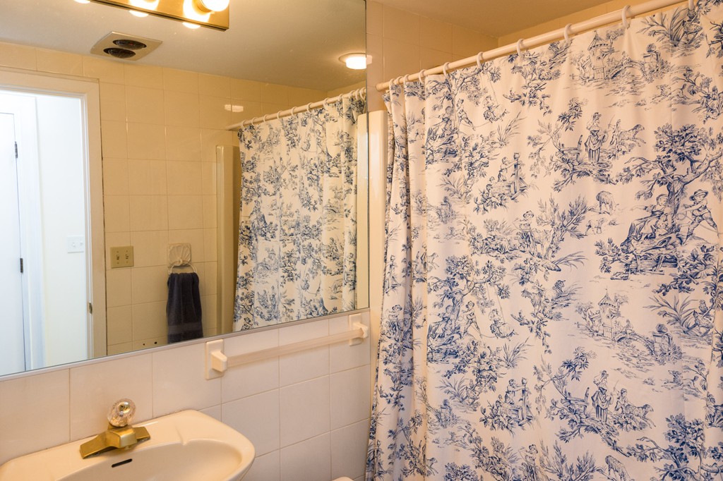 63 Oceanside Drive, Unit 63 Hull, MA 02045 - Photo 27 of 30 a bathroom with a shower curtain and a toilet sink