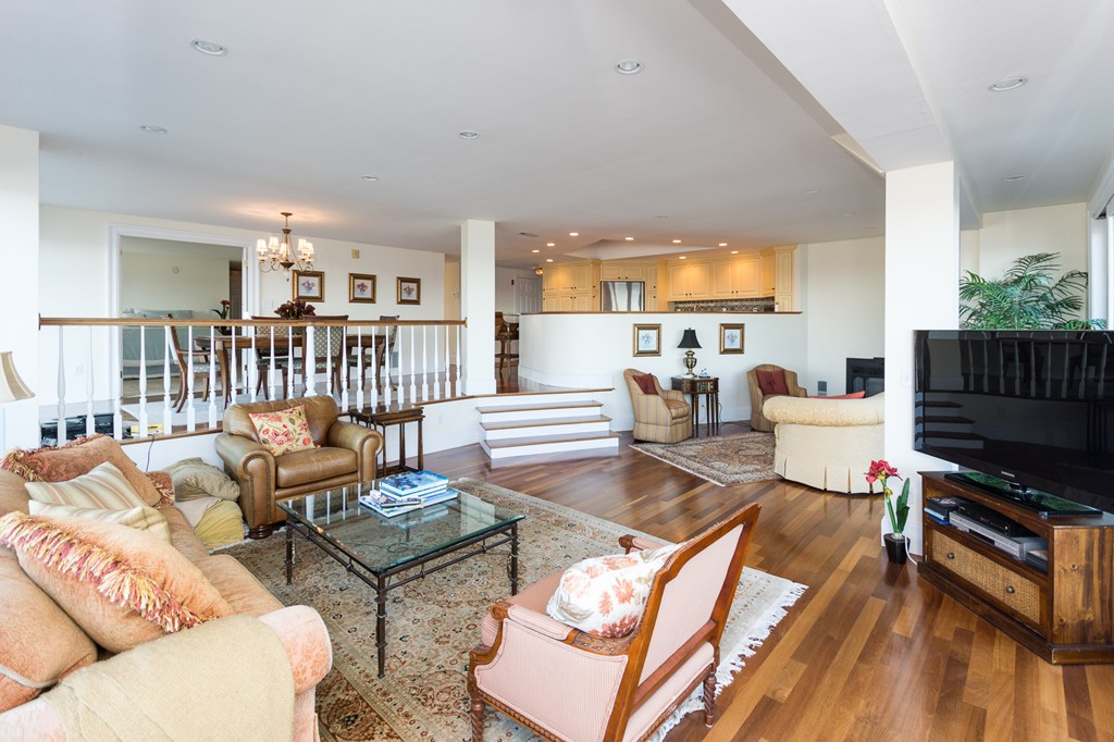 63 Oceanside Drive, Unit 63 Hull, MA 02045 - Photo 7 of 30 a living room with furniture a flat screen tv and a refrigerator