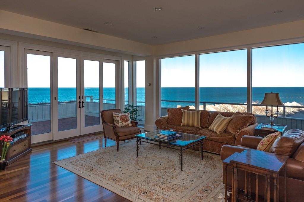 63 Oceanside Drive, Unit 63 Hull, MA 02045 - Photo 8 of 30 a living room with furniture and a floor to ceiling window