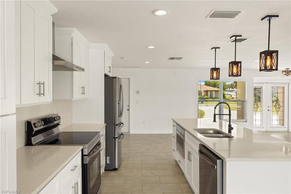 13846 Sleepy Hollow Lane Fort Myers, FL 33905 - Photo 12 of 46 a kitchen with a sink stove and refrigerator