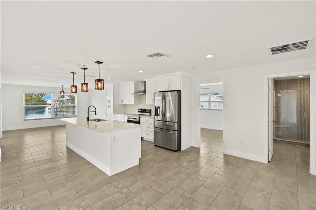 13846 Sleepy Hollow Lane Fort Myers, FL 33905 - Photo 13 of 46 a white kitchen with cabinets and stainless steel appliances