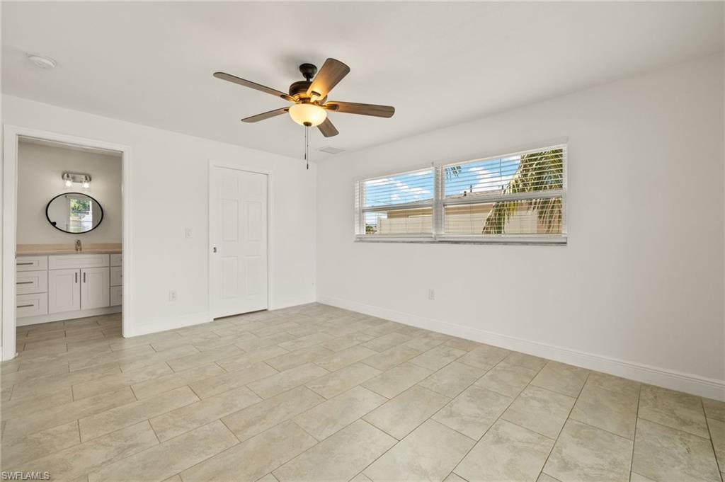 13846 Sleepy Hollow Lane Fort Myers, FL 33905 - Photo 20 of 46 an empty room with windows and fan