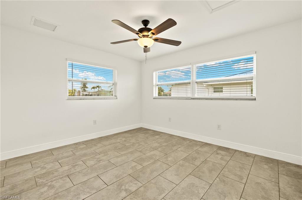 13846 Sleepy Hollow Lane Fort Myers, FL 33905 - Photo 22 of 46 an empty room with wooden floor and windows