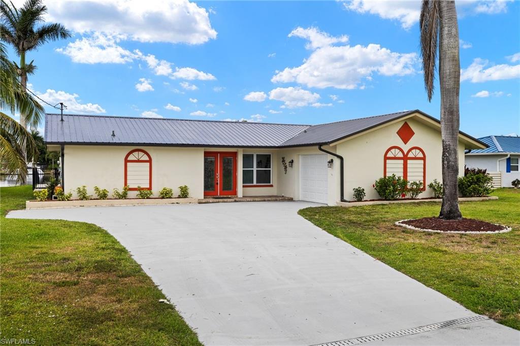 13846 Sleepy Hollow Lane Fort Myers, FL 33905 - Photo 3 of 46 a front view of a house with a yard