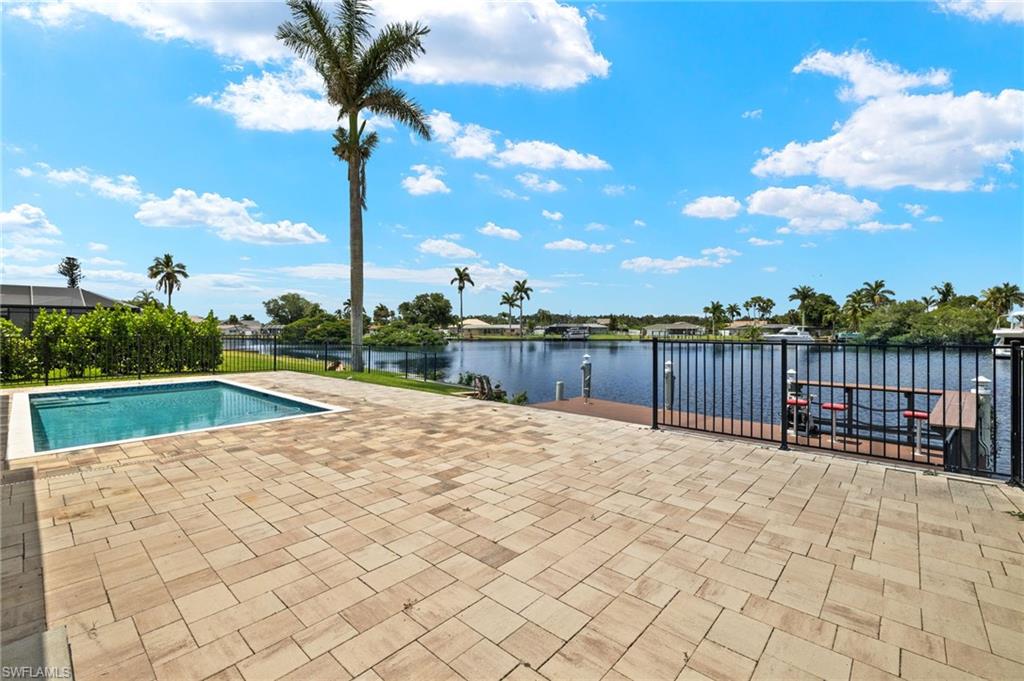 13846 Sleepy Hollow Lane Fort Myers, FL 33905 - Photo 31 of 46 a view of swimming pool with lake and trees in the background