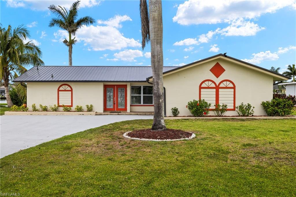 13846 Sleepy Hollow Lane Fort Myers, FL 33905 - Photo 46 of 46 a front view of a house with a yard and garage