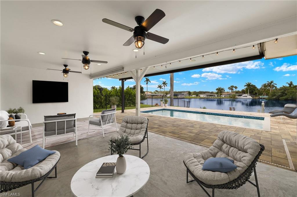 13846 Sleepy Hollow Lane Fort Myers, FL 33905 - Photo 5 of 46 a living room with fireplace furniture and a flat screen tv