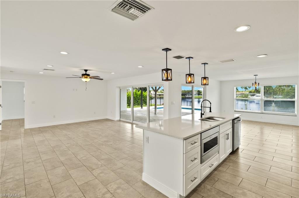 13846 Sleepy Hollow Lane Fort Myers, FL 33905 - Photo 9 of 46 a kitchen with a stove and a view of living room