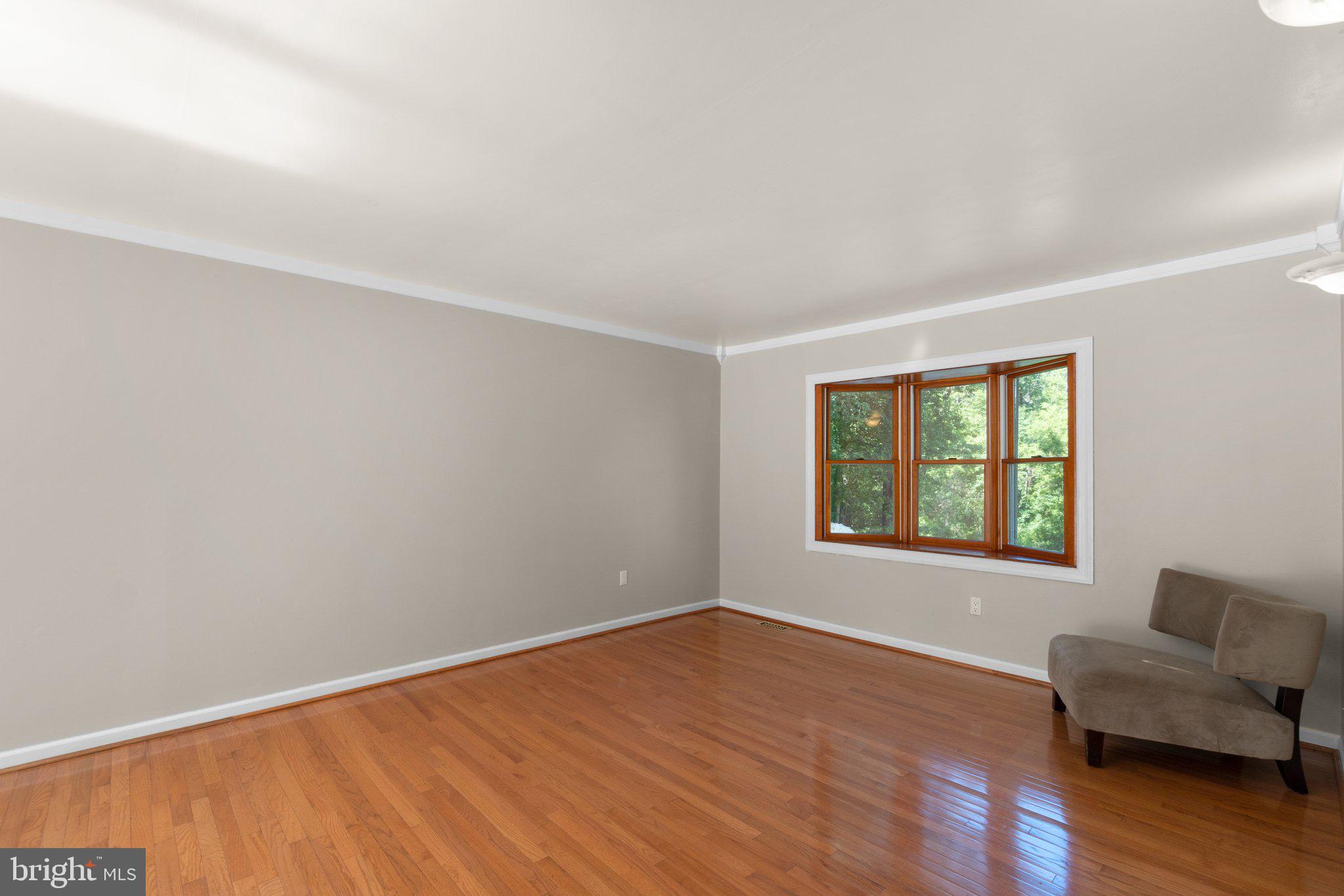 4003 Falls Road Manchester, MD 21102 - Photo 4 of 30 a view of an empty room with wooden floor and a window