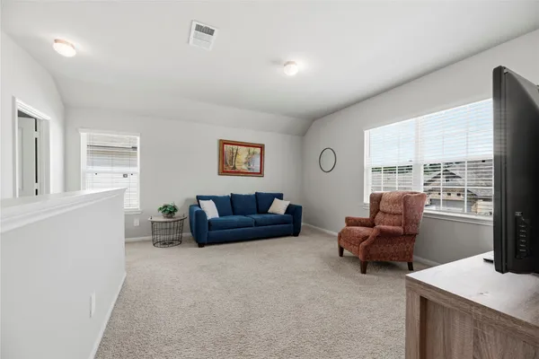 a bedroom with a bed and a dresser in it