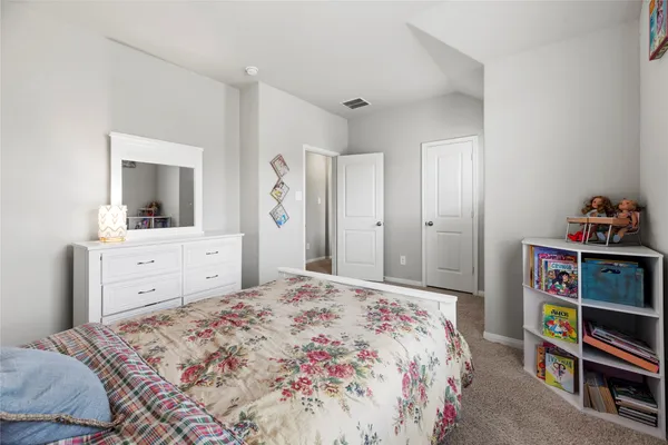 a room with a bed and wooden floor