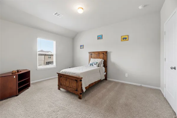 a view of a chair and table in backyard of the house