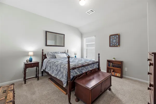 a view of a chair and table in backyard of the house