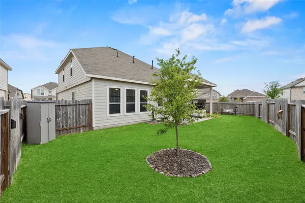 a front view of a house with a yard and trees