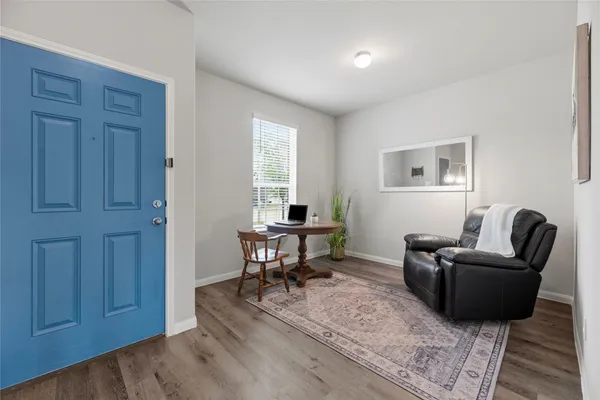 a view of a hallway with wooden floor and entryway