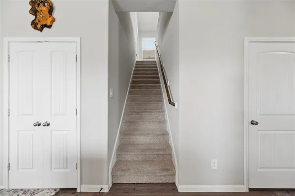 a kitchen with stainless steel appliances granite countertop a refrigerator a stove top oven a sink dishwasher and microwave oven with wooden floor