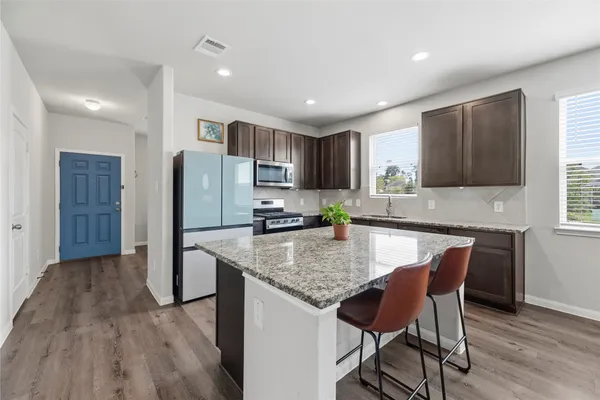 a view of a dining room with furniture and wooden floor