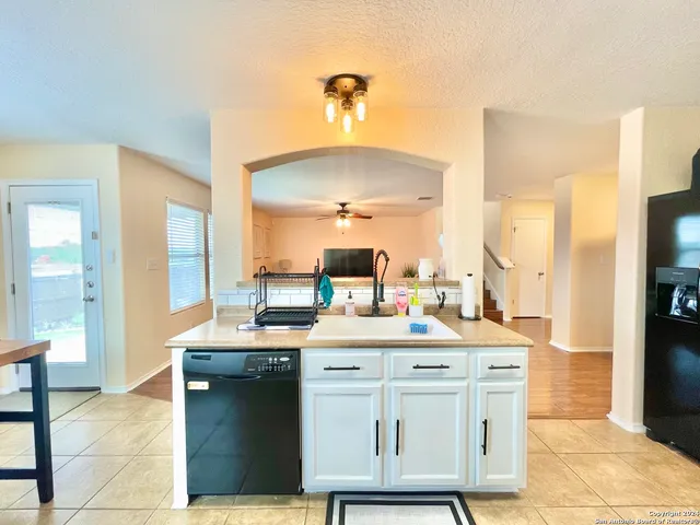 a kitchen with a sink cabinets and appliances