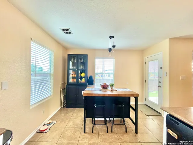 a view of a dining room with furniture and window