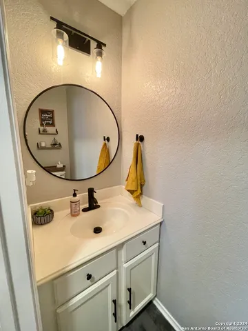 a bathroom with a sink and mirror