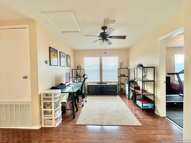 a view of a livingroom with workspace and a window