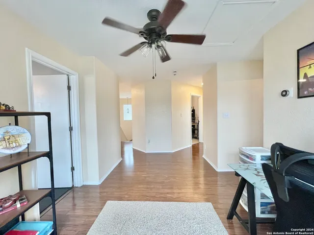 a view of a workspace with furniture and wooden floor