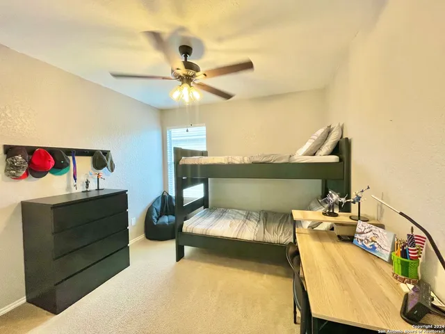 a bedroom with furniture and a chandelier