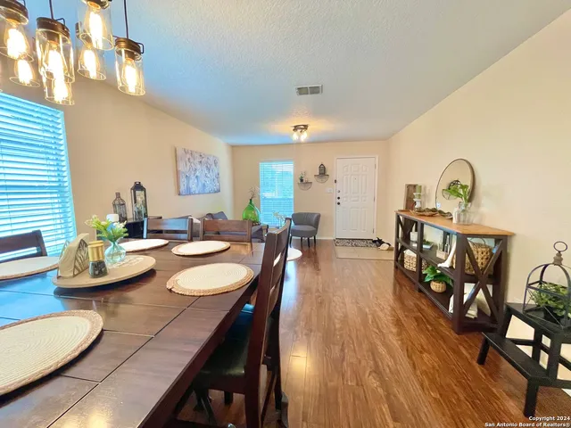 a view of a dining room with furniture and wooden floor