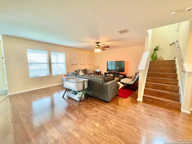 a living room with furniture window and wooden floor