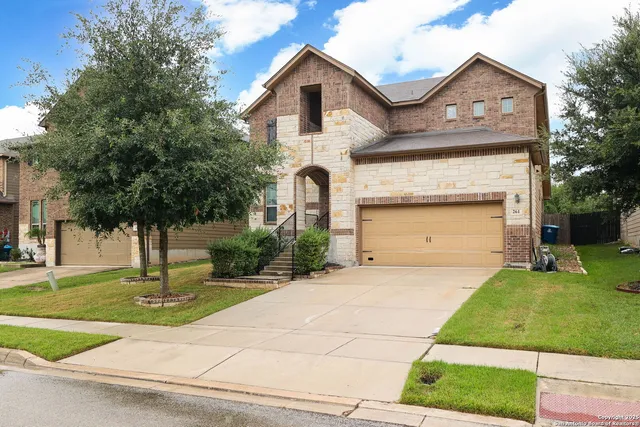 a front view of a house with a yard and garage