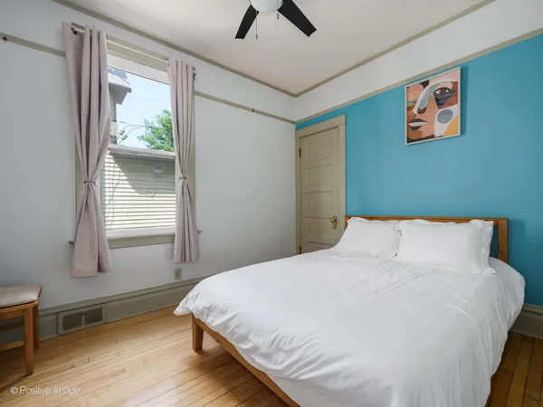 a bedroom with a large bed and a window