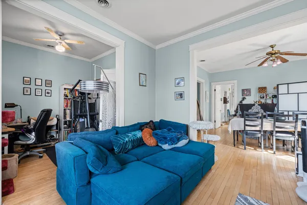 a living room with furniture and wooden floor