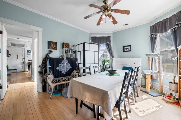 a view of a dining room with furniture and wooden floor