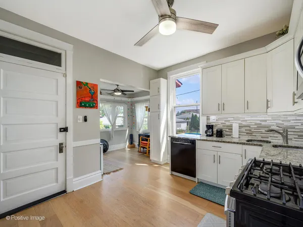 a kitchen with granite countertop stainless steel appliances and wooden cabinets