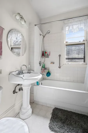 a bathroom with a sink a mirror and a bathtub