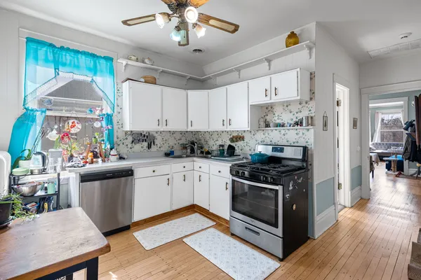 a kitchen with stainless steel appliances granite countertop a stove and a refrigerator