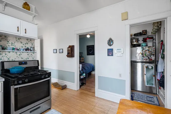 a kitchen with stainless steel appliances a stove a microwave and a refrigerator