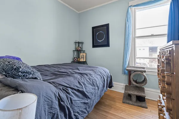 a bedroom with a bed and a window