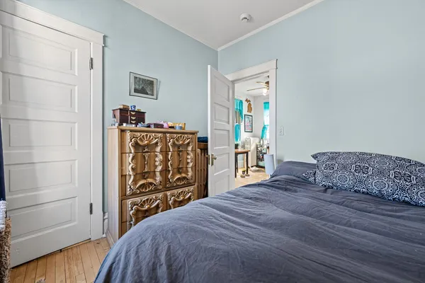 a bedroom with a bed and a dresser