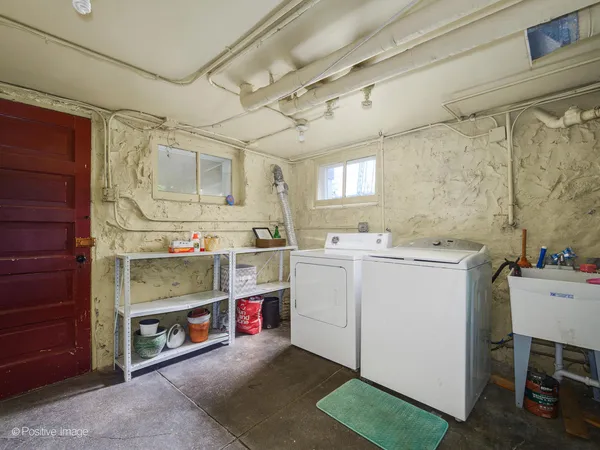 a utility room with cabinets dryer and washer