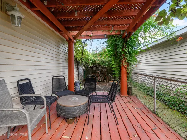 a view of outdoor sitting area with furniture and wooden floor