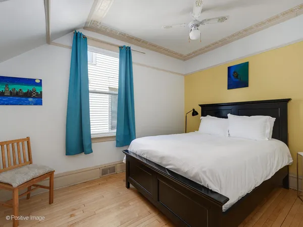 a large bed sitting in a bedroom next to a window
