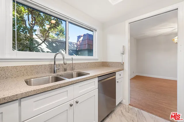 a view white cabinets and a sink
