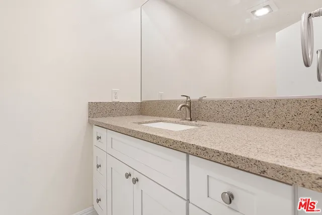 a bathroom with a sink and vanity
