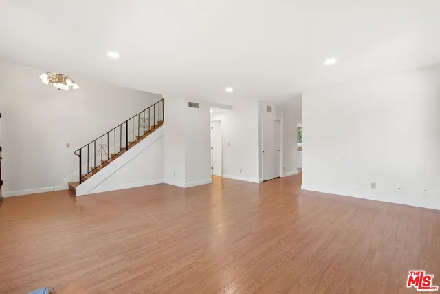 a view of an entryway with wooden floor
