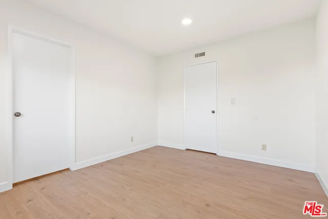 an empty room with wooden floor