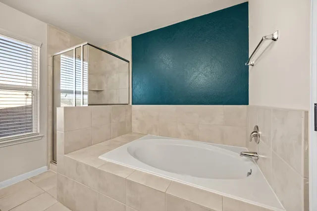 a bathroom with a bathtub shower sink vanity and toilet
